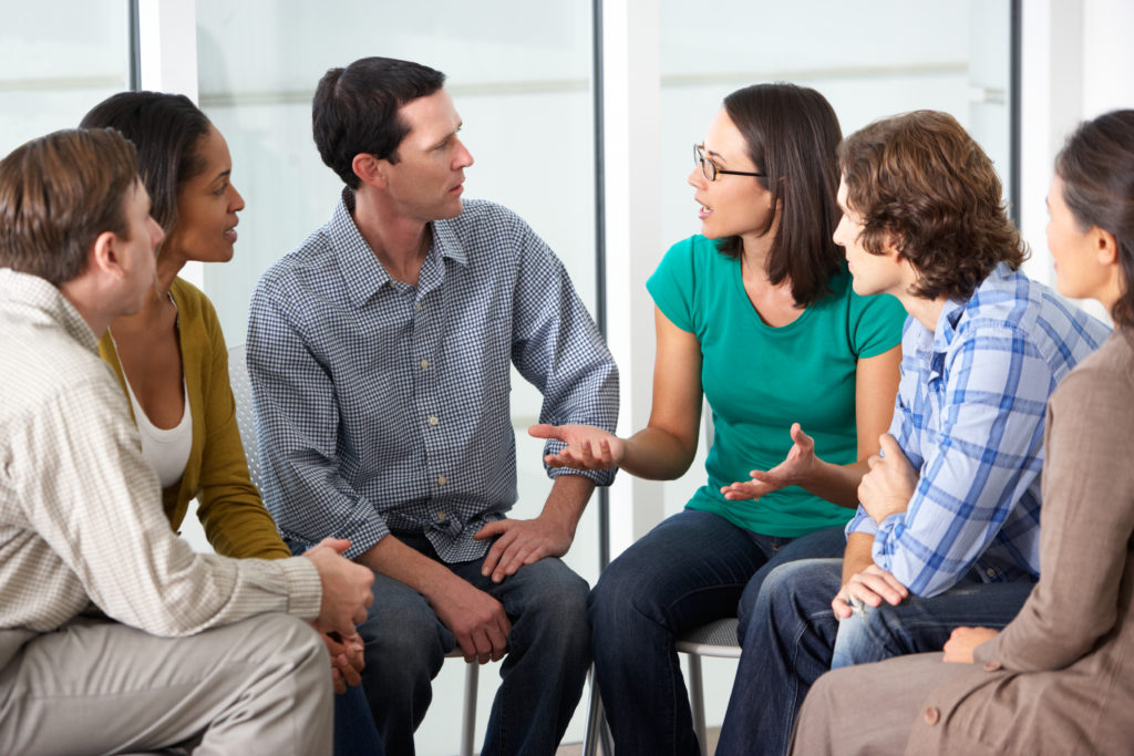 Men and women talking in a support group