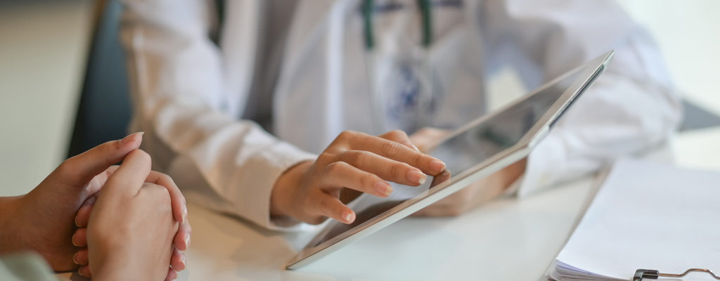 Doctor showing patient something off a tablet