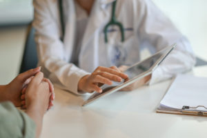 Doctor showing patient something off a tablet